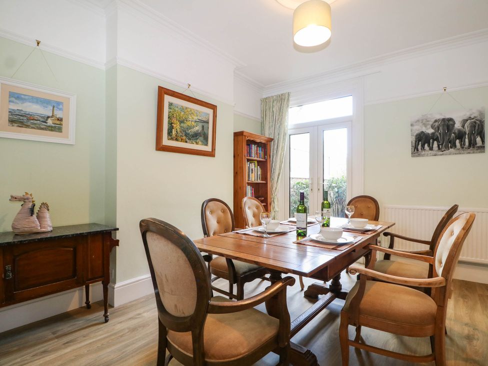 A dining room with a table set for dinner at Fernleigh in Margate
