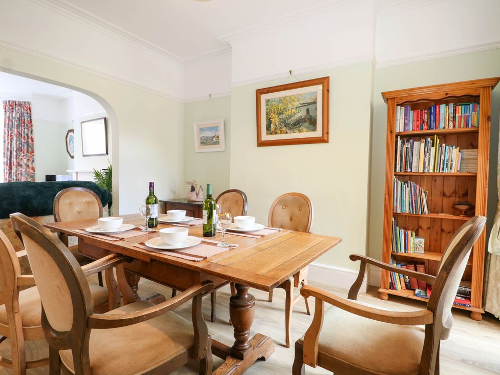 A dining room with a wooden table and chairs at Fernleigh in Margate