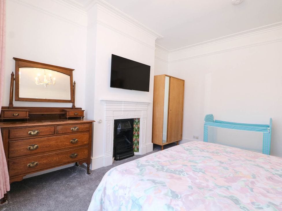 A bedroom with a bed, television, and dresser at Fernleigh in Margate
