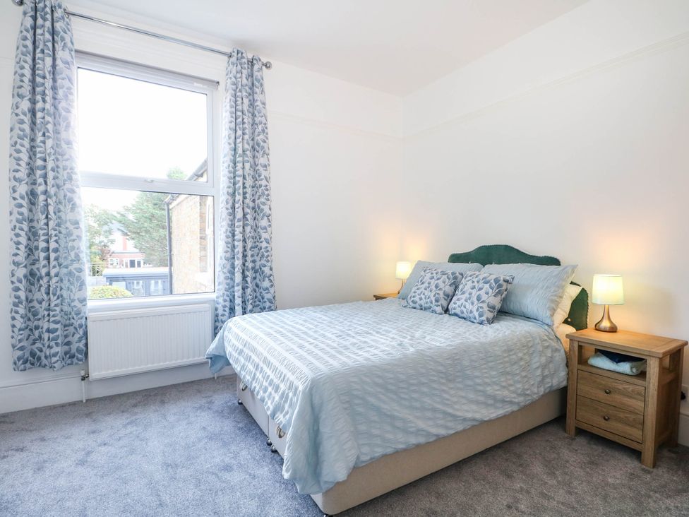 A bedroom with a bed and bedside table at Fernleigh in Margate