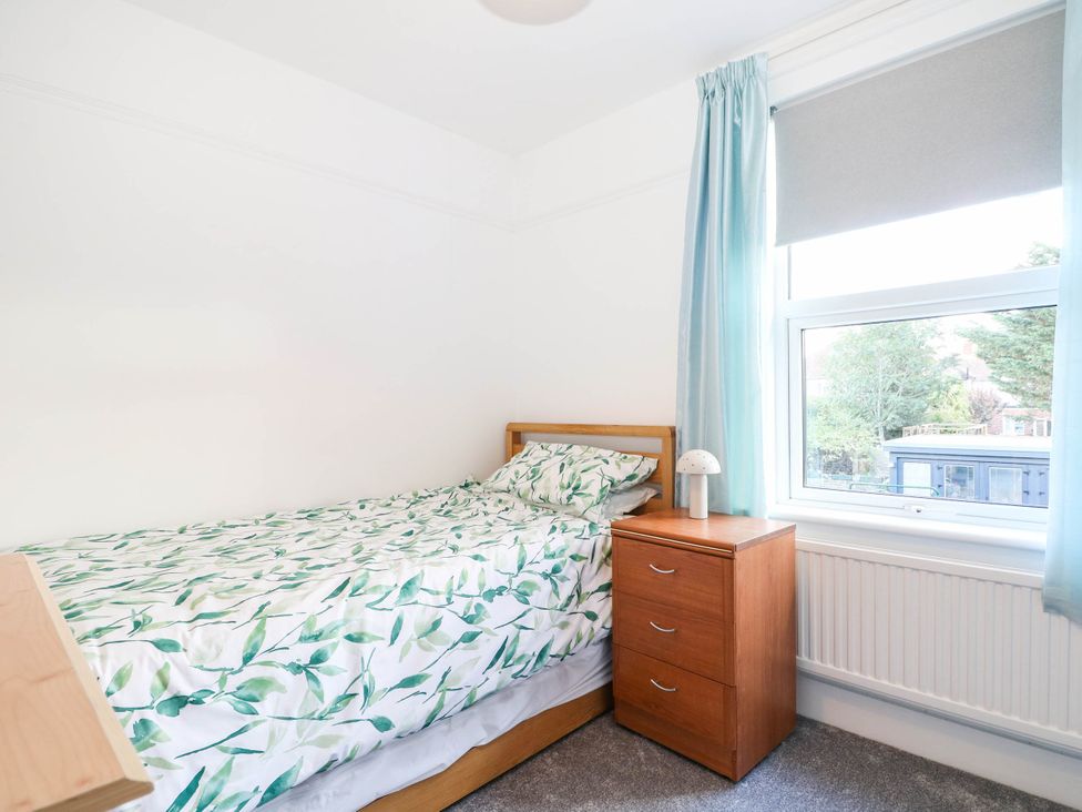 A bedroom with a bed and nightstand at Fernleigh in Margate