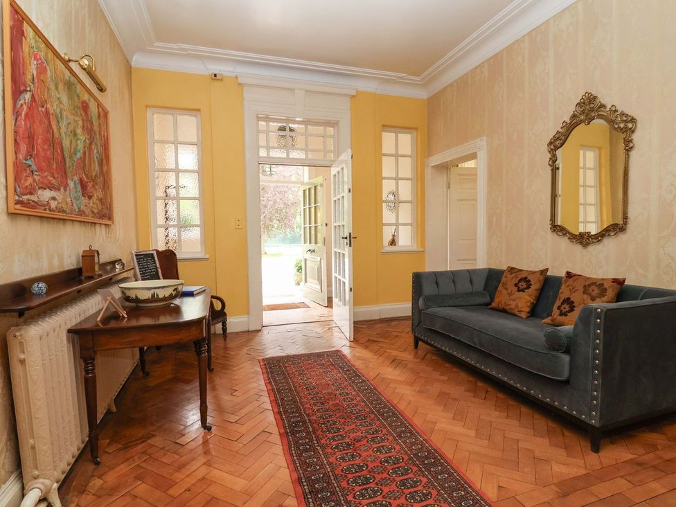 A hallway with a sofa and a table at Parkfields House in Stoke-on-Trent