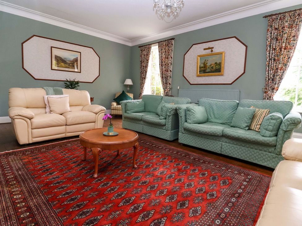 A living room with sofas and a coffee table at Parkfields House in Stoke-on-Trent