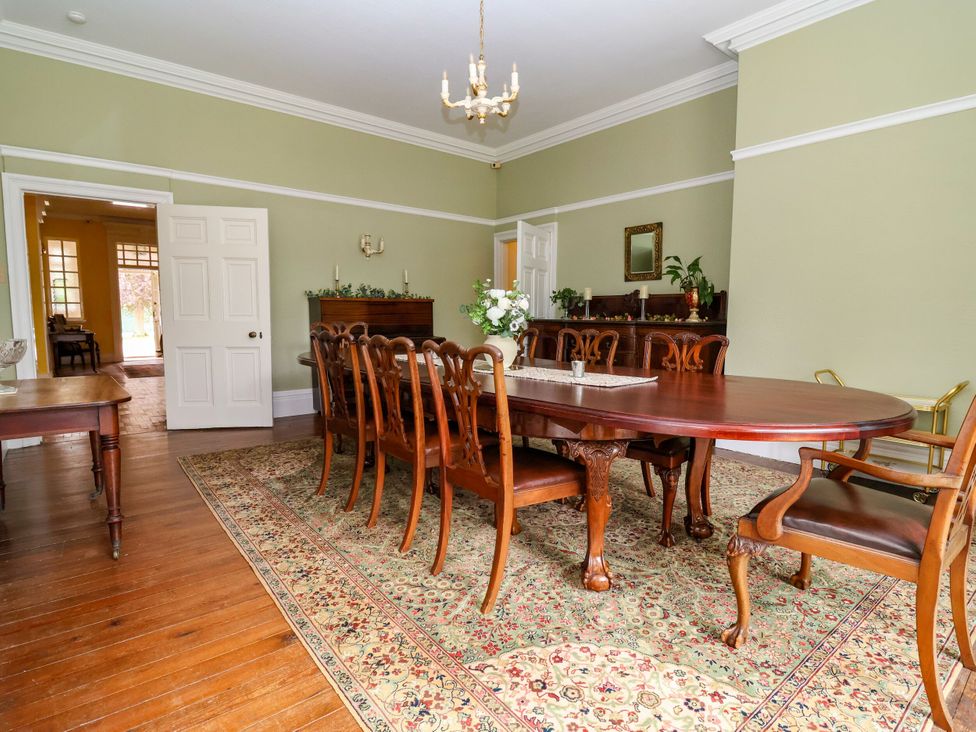 A dining room with a table and chairs at Parkfields House in Stoke-on-Trent
