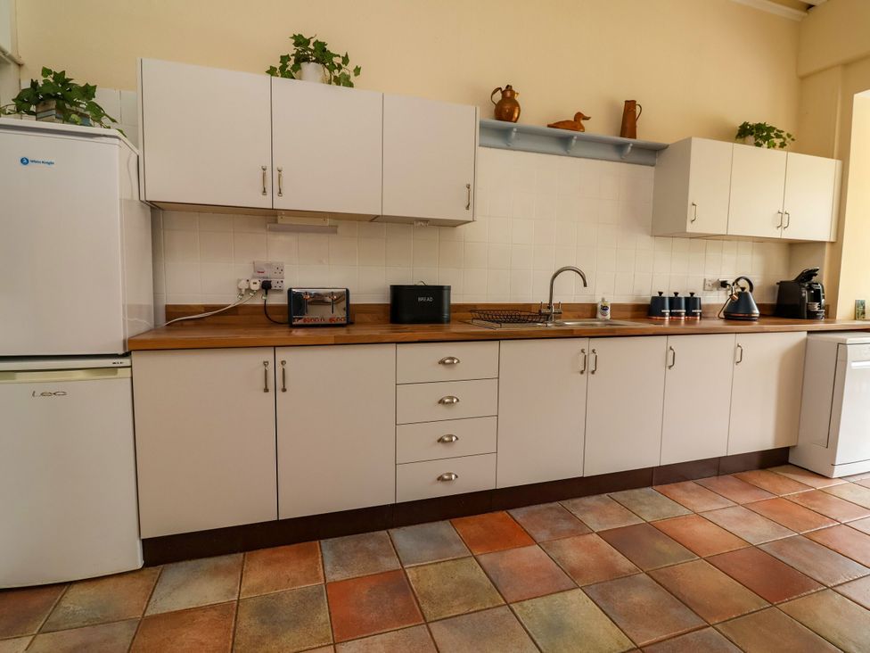 A kitchen with cabinets and appliances at Parkfields House Stoke-on-Trent