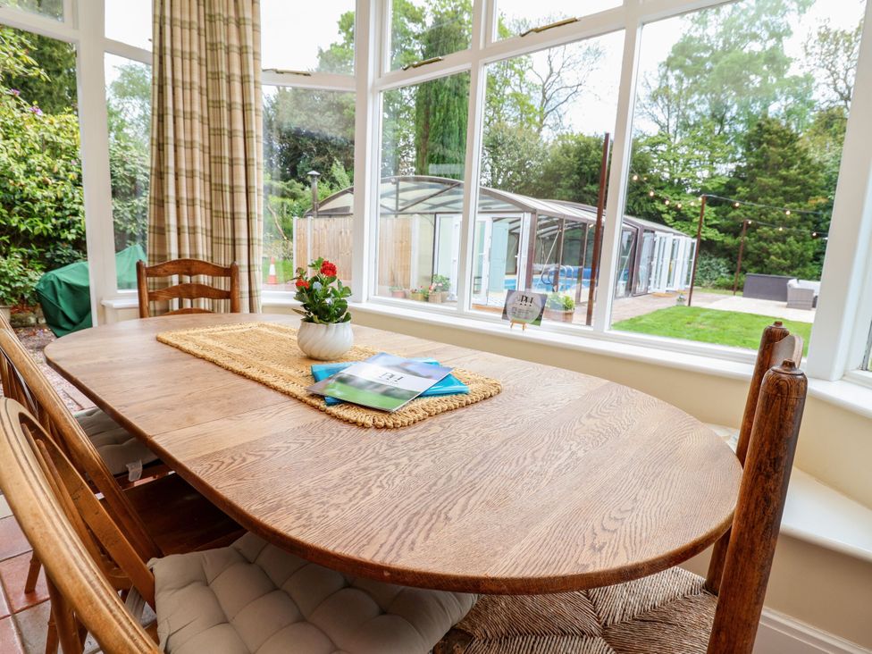 A dining room with a wooden table and chairs at Parkfields House in Stoke-on-Trent