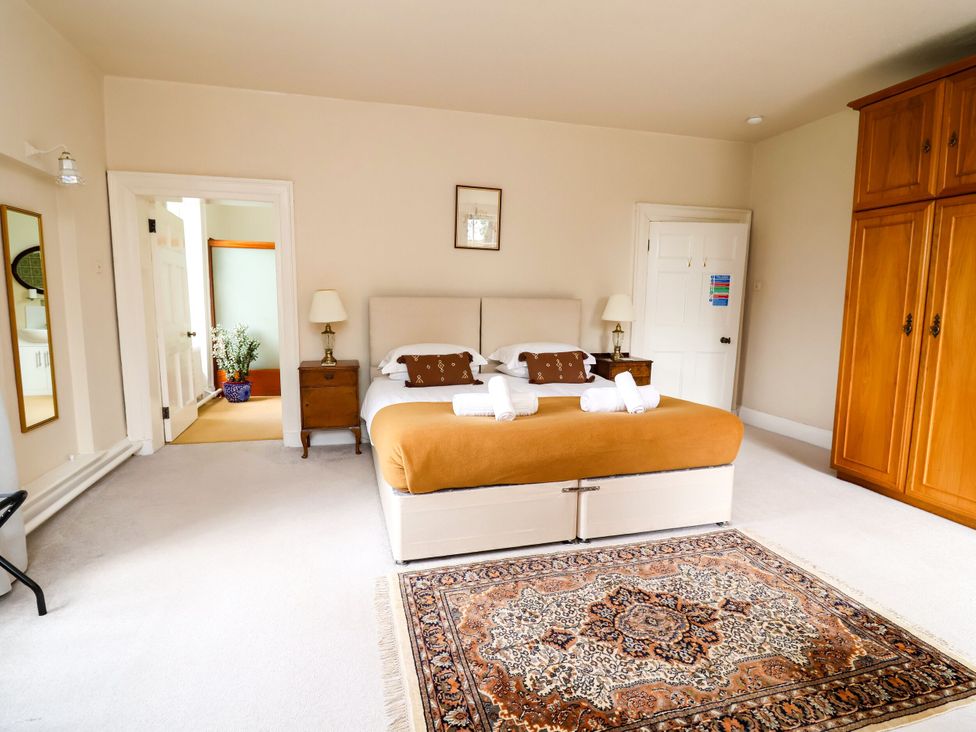 A bedroom with a bed and wardrobe at Parkfields House in Stoke-on-Trent