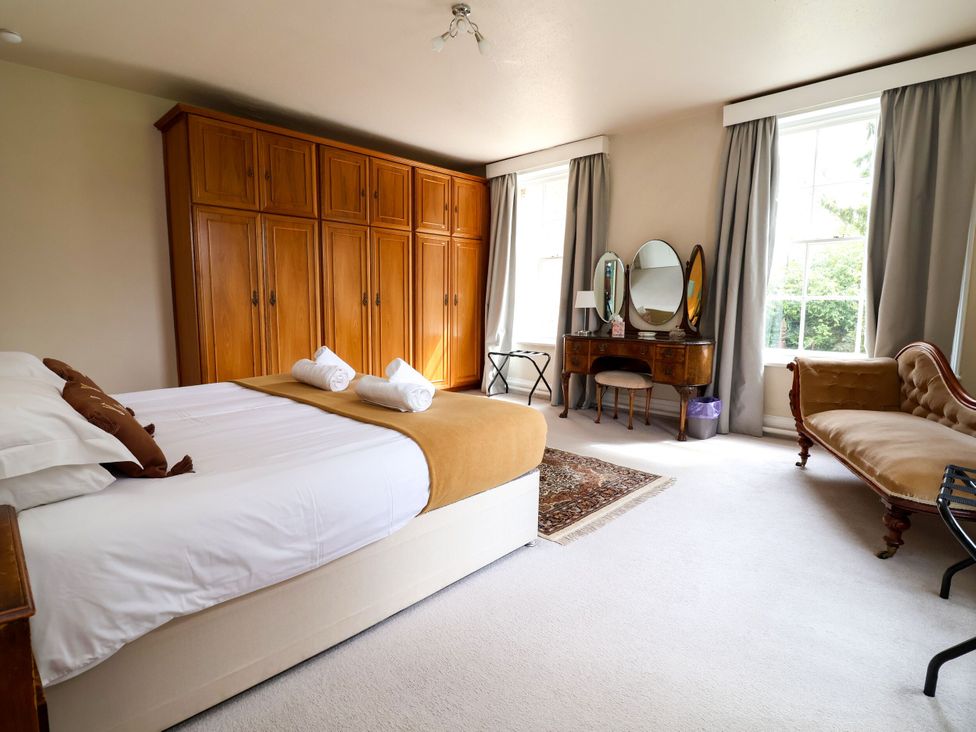 A bedroom with a bed and wardrobe at Parkfields House in Stoke-on-Trent