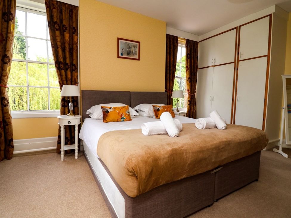 A bedroom with a bed and bedside table at Parkfields House in Stoke-on-Trent