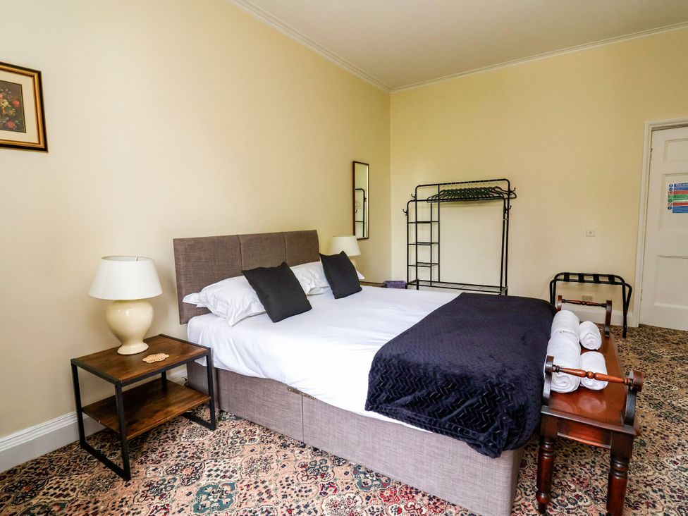 A bedroom with a bed and bedside table at Parkfields House in Stoke-on-Trent