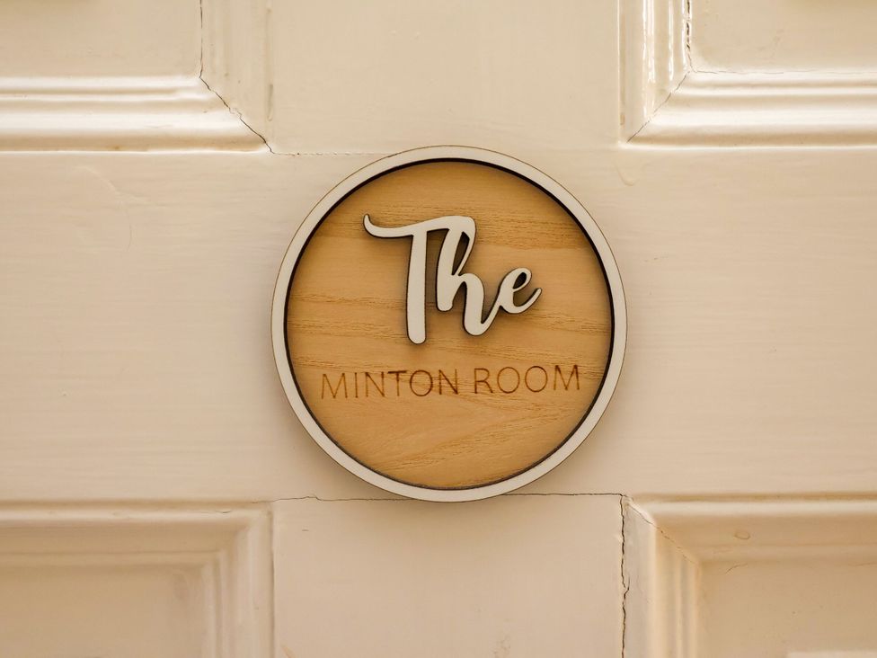 A room sign labeled 'The Minton Room'