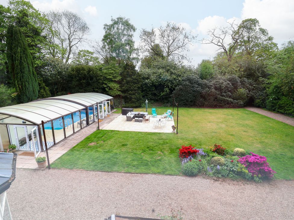 An outdoor garden with a swimming pool and patio area at Parkfields House Stoke-on-Trent