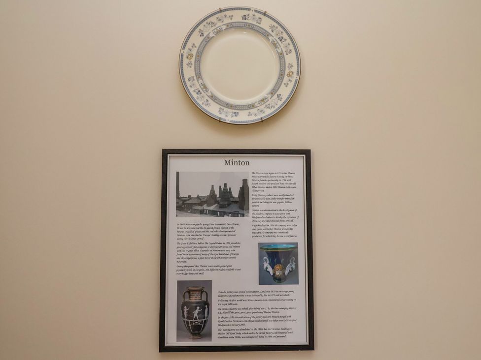 A wall display with a decorative plate and information about Minton at Parkfields House Stoke-on-Trent