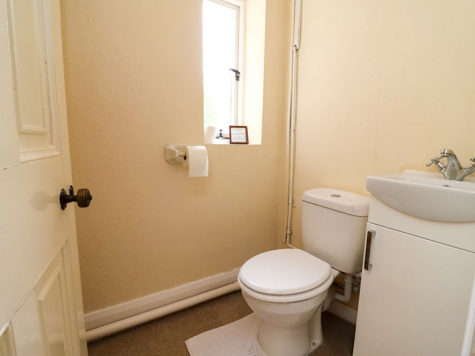 A bathroom with a toilet and sink at Parkfields House in Stoke-on-Trent