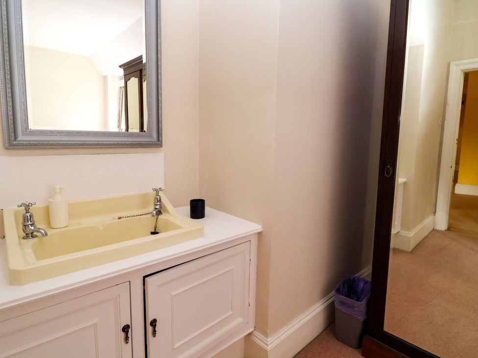 A bathroom with a sink and mirror at Parkfields House in Stoke-on-Trent