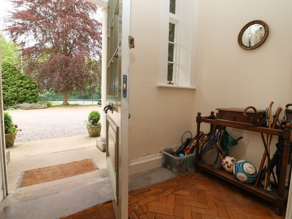 A hallway with a side table and sports equipment at Parkfields House Stoke-on-Trent