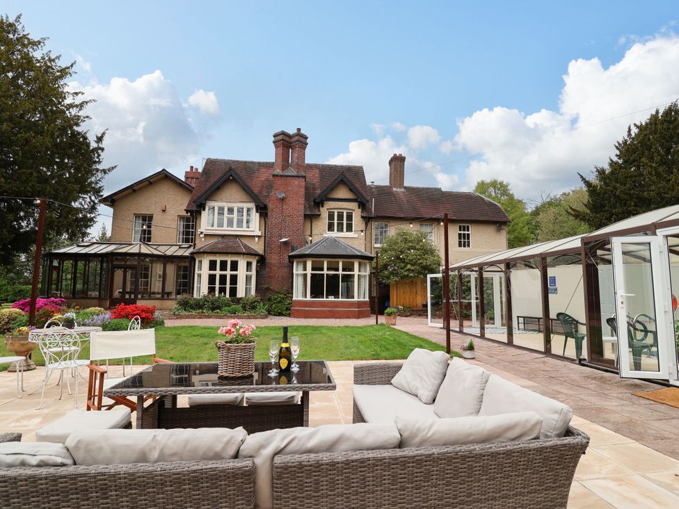 A house and garden with seating area and patio at Parkfields House Stoke-on-Trent