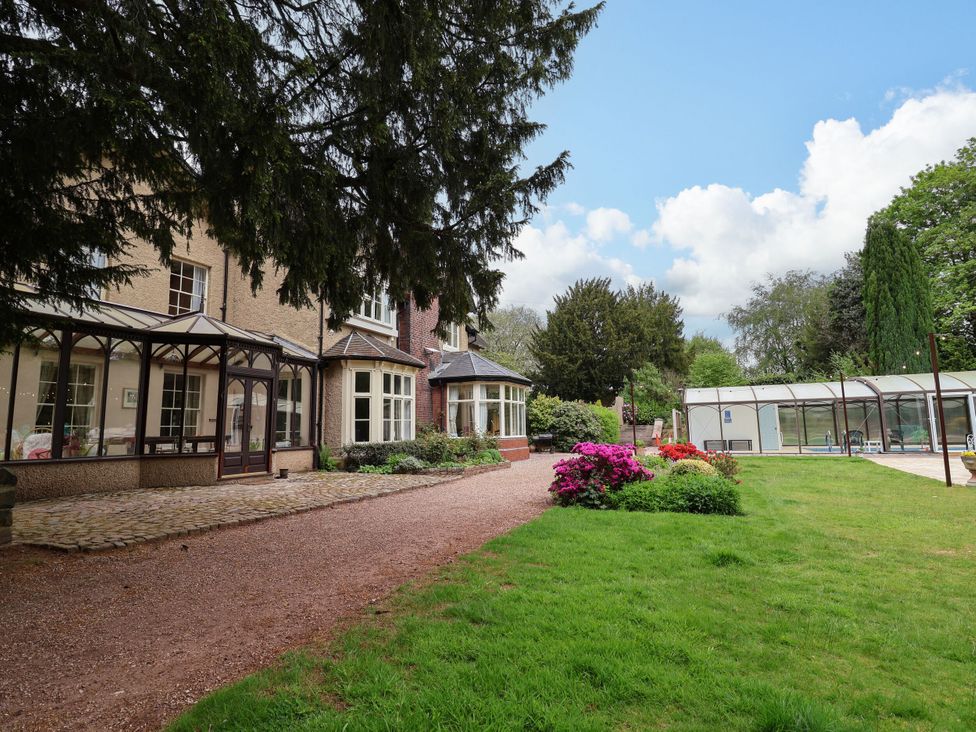 A house with conservatory and pool in the garden at Parkfields House in Stoke-on-Trent