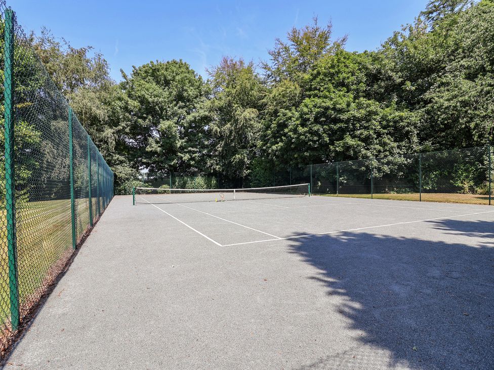 A tennis court enclosed by a fence at Parkfields House Tittensor near Barlaston