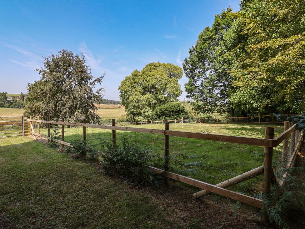 A garden area with trees and a fence at Parkfields House Tittensor near Barlaston