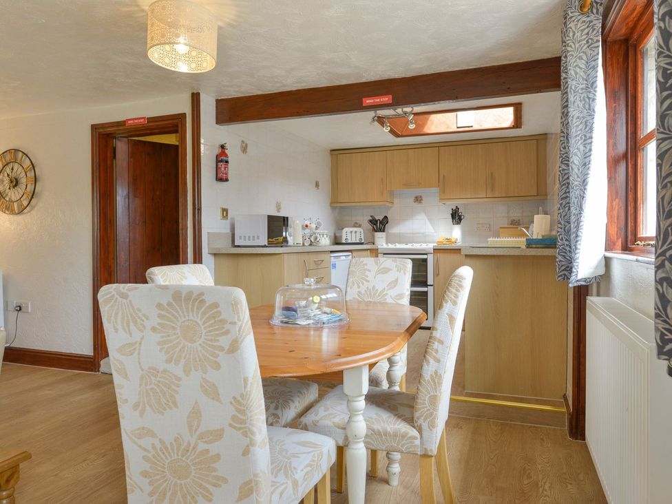 A dining room with a table and chairs in Pillhead Cart Linhay Bideford