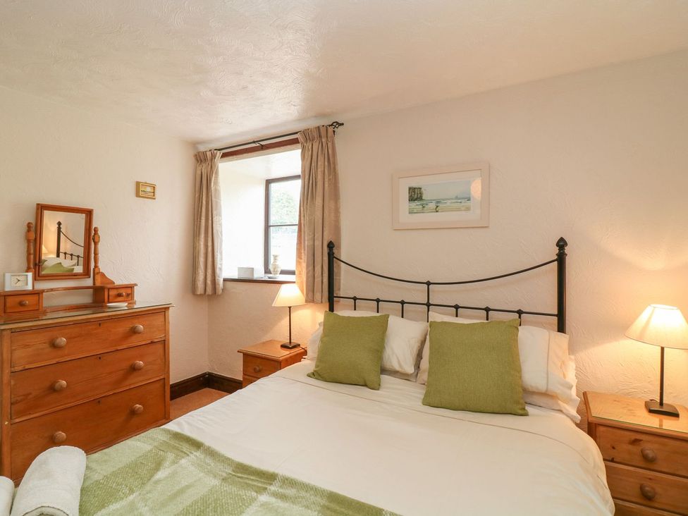 A bedroom with a bed and dresser at Pillhead Cart Linhay Bideford