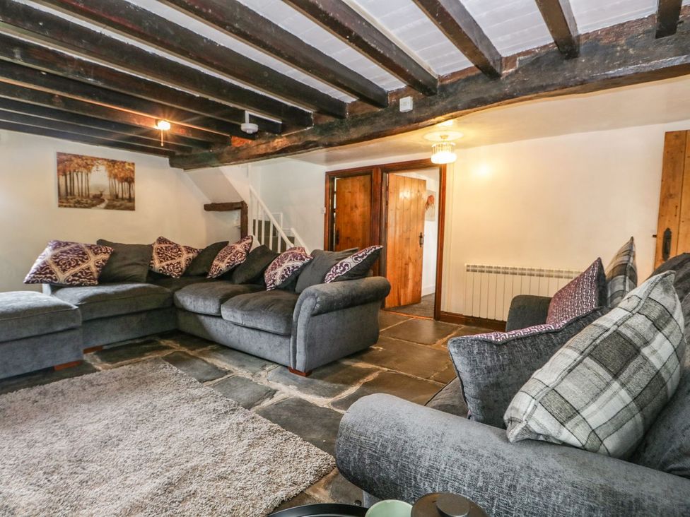 A living room with a sofa and a rug at Brigg House in Broughton-in-Furness