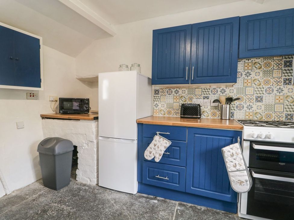 A kitchen with appliances and cabinets at Brigg House in Broughton-in-Furness