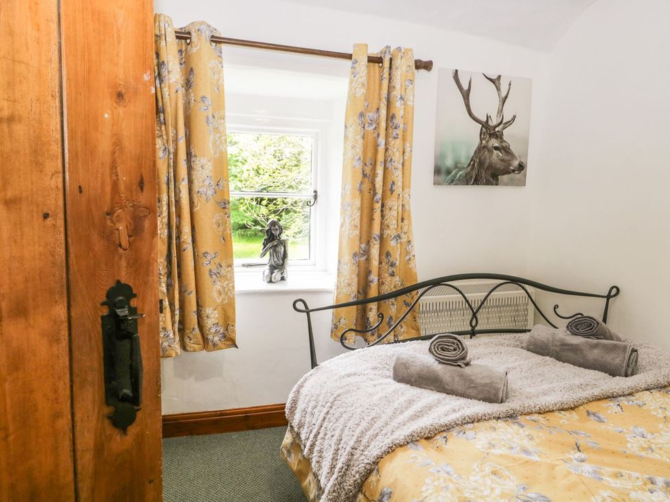 A bedroom with a bed and window at Brigg House in Broughton-in-Furness