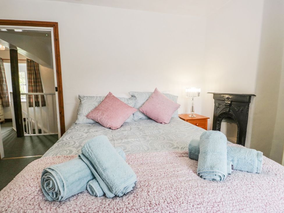 A bedroom with a bed and towels at Brigg House in Broughton-in-Furness