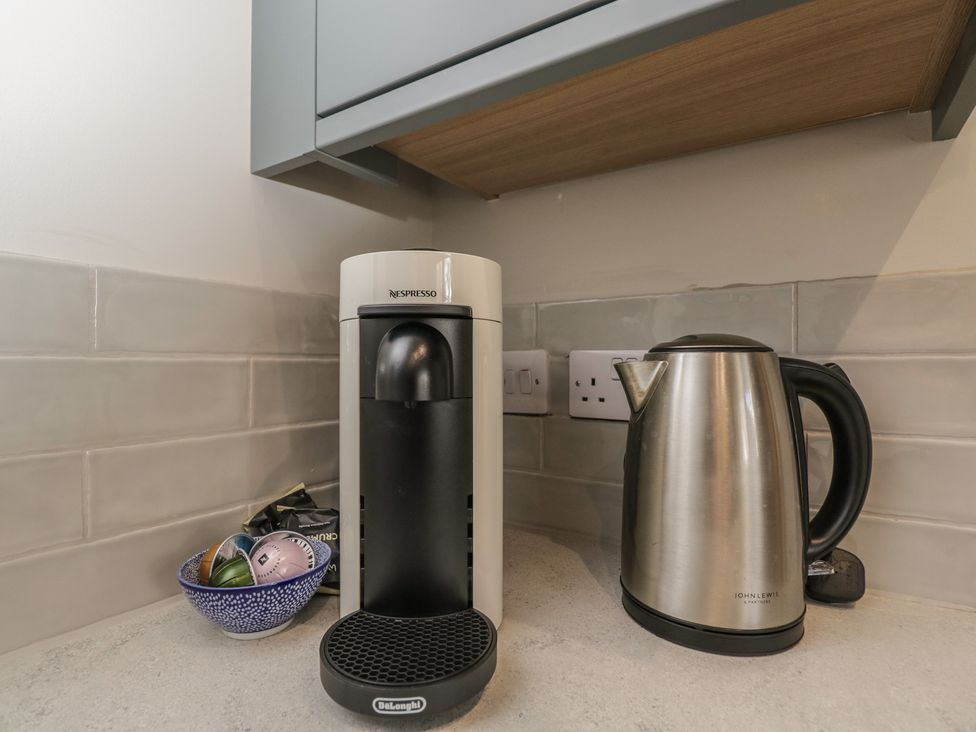 A kitchen with a Nespresso machine and an electric kettle at Foxglove in Stratton Audley near Bicester