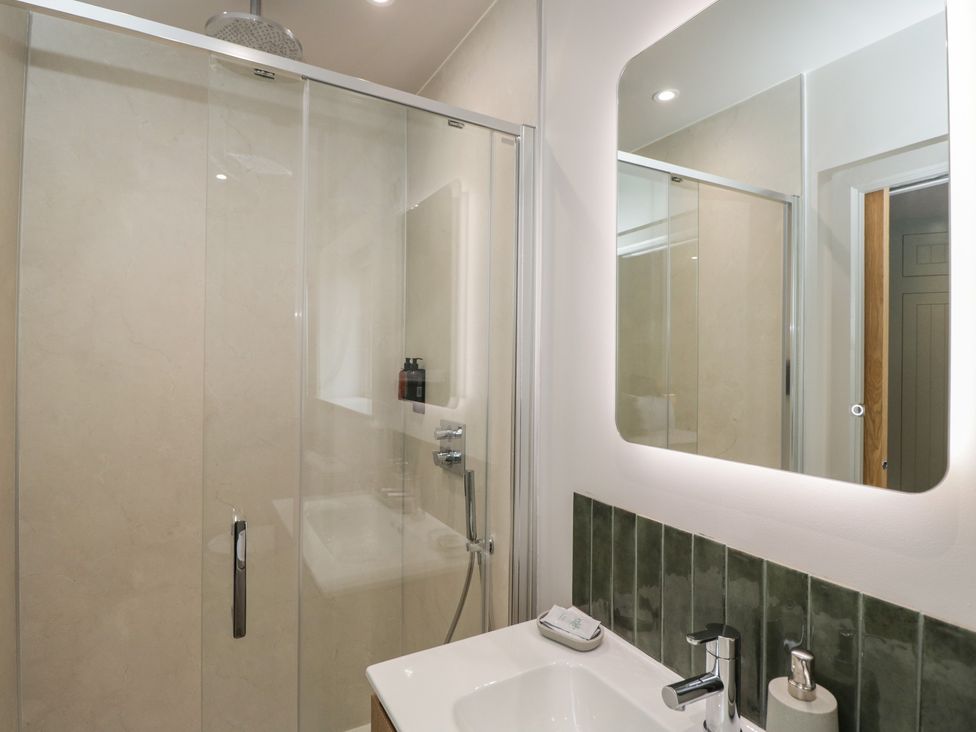A bathroom with a shower and sink at Foxglove in Stratton Audley near Bicester