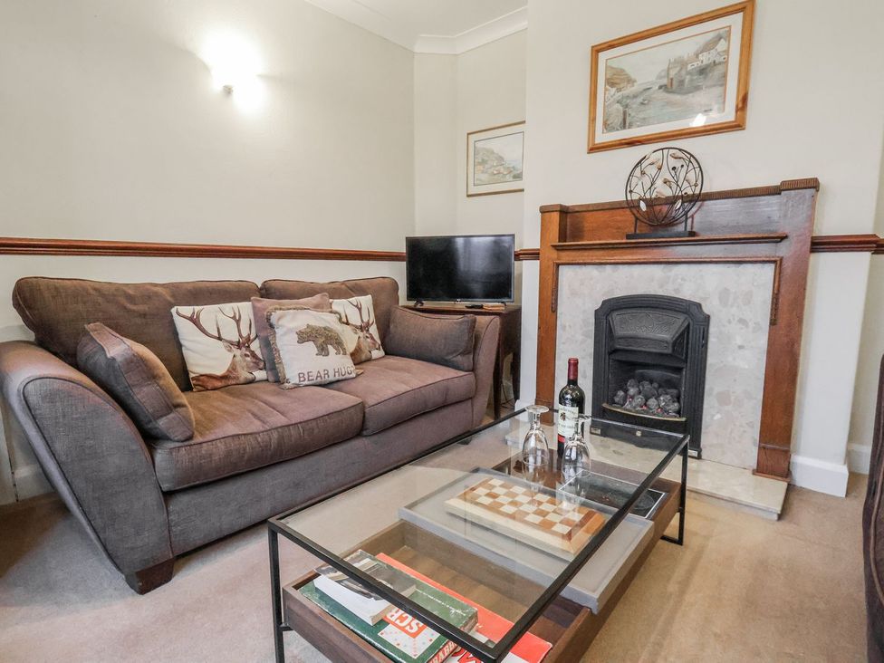 A living room with a sofa and television at Beachcrest in Whitby