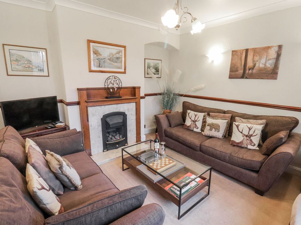 A living room with a fireplace and coffee table at Beachcrest in Whitby
