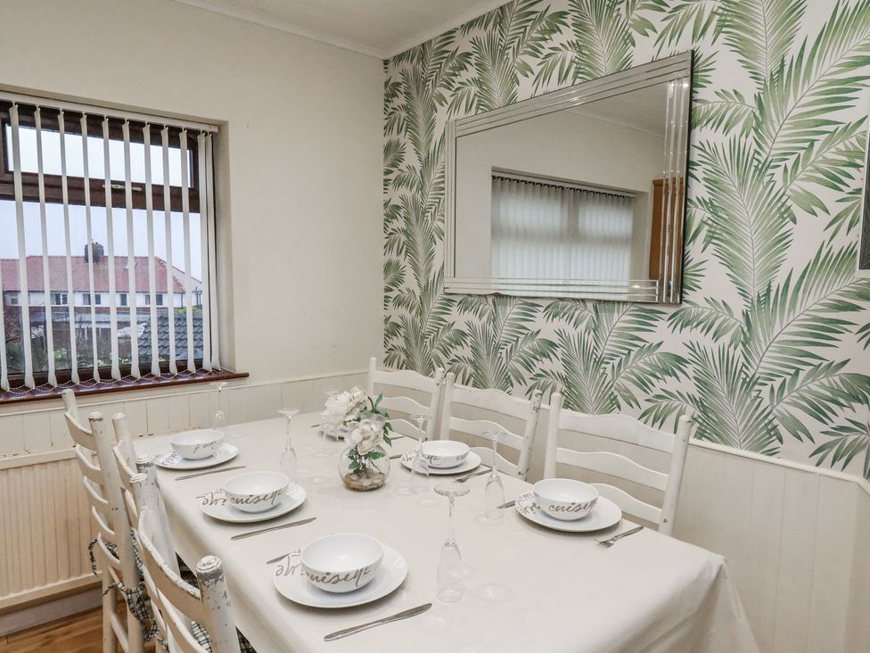A dining room with a table set for dinner at Beachcrest in Whitby