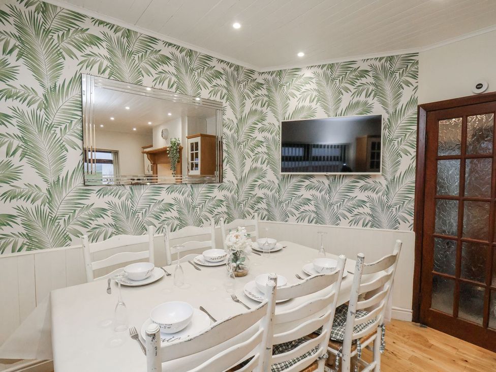 A dining room with a table and chairs at Beachcrest in Whitby
