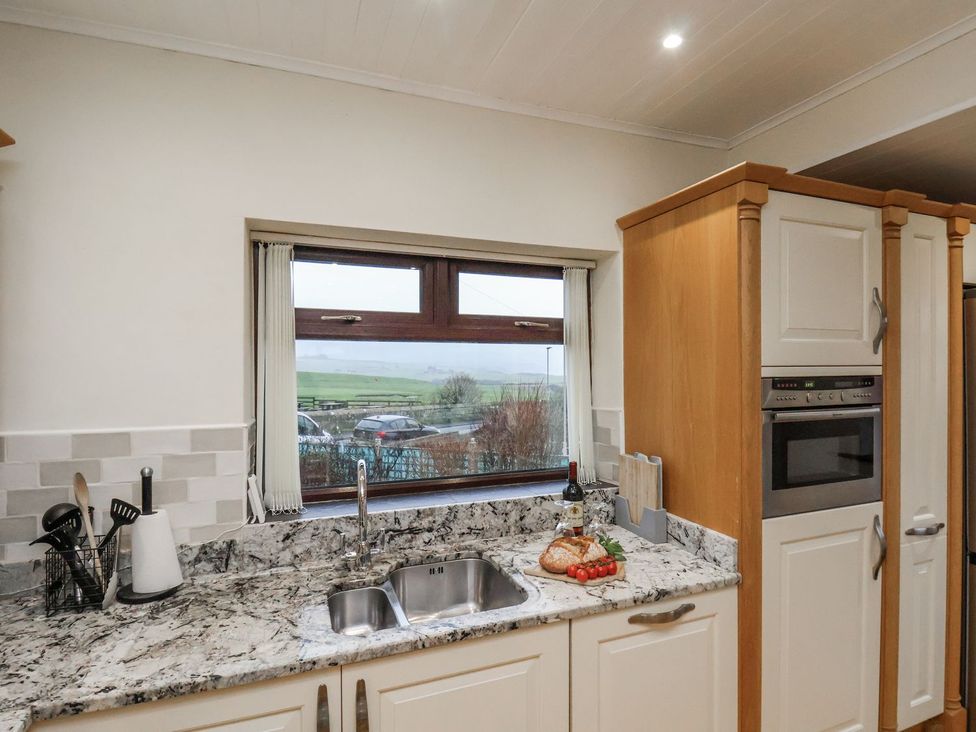 A kitchen with a sink and window at Beachcrest in Whitby