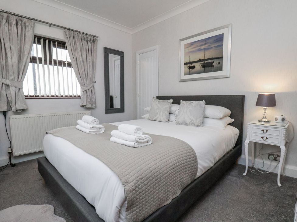 A bedroom with a double bed and nightstand at Beachcrest in Whitby