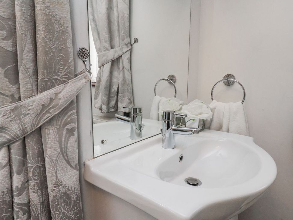 A bathroom with a sink and towels at Beachcrest in Whitby