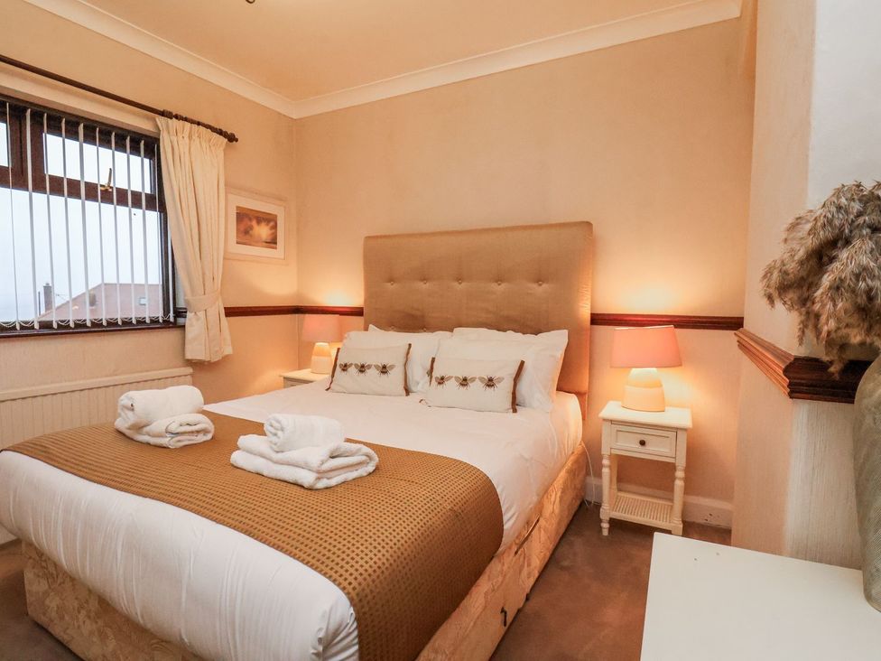 A bedroom with a bed and bedside table at Beachcrest in Whitby
