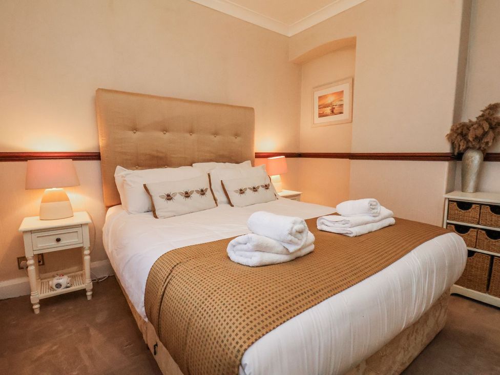 A bedroom with a bed and bedside table at Beachcrest in Whitby
