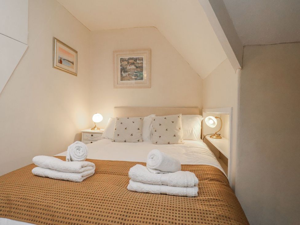 A bedroom with a bed and towels arranged at Beachcrest in Whitby