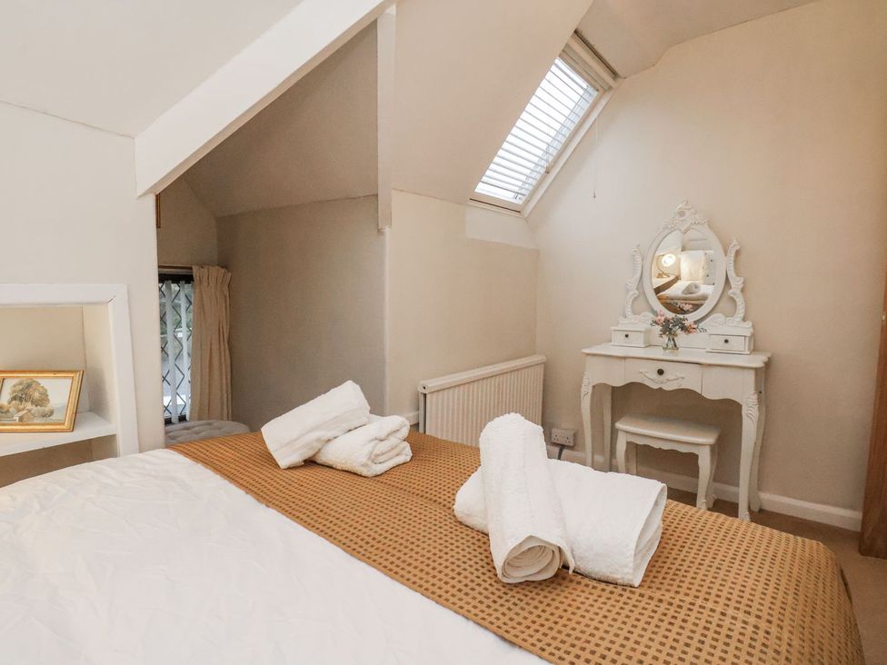 A bedroom with a bed and dressing table at Beachcrest in Whitby