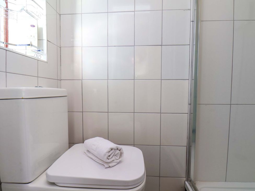 A bathroom with a toilet and towel at Beachcrest in Whitby