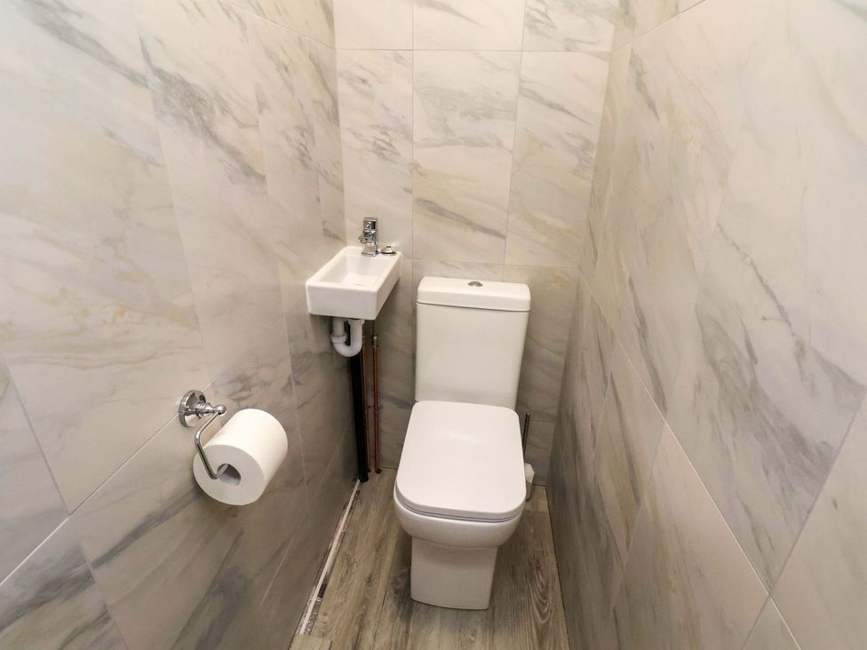A bathroom with a toilet and sink at Beachcrest in Whitby