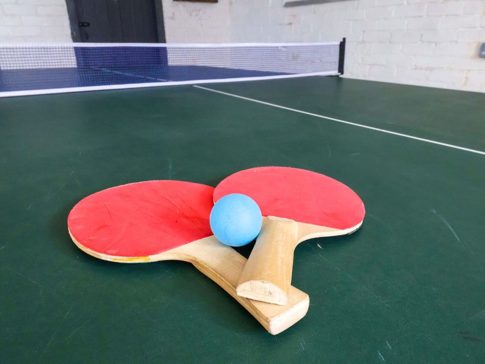 A ping pong setup with paddles and a ball at Beachcrest in Whitby