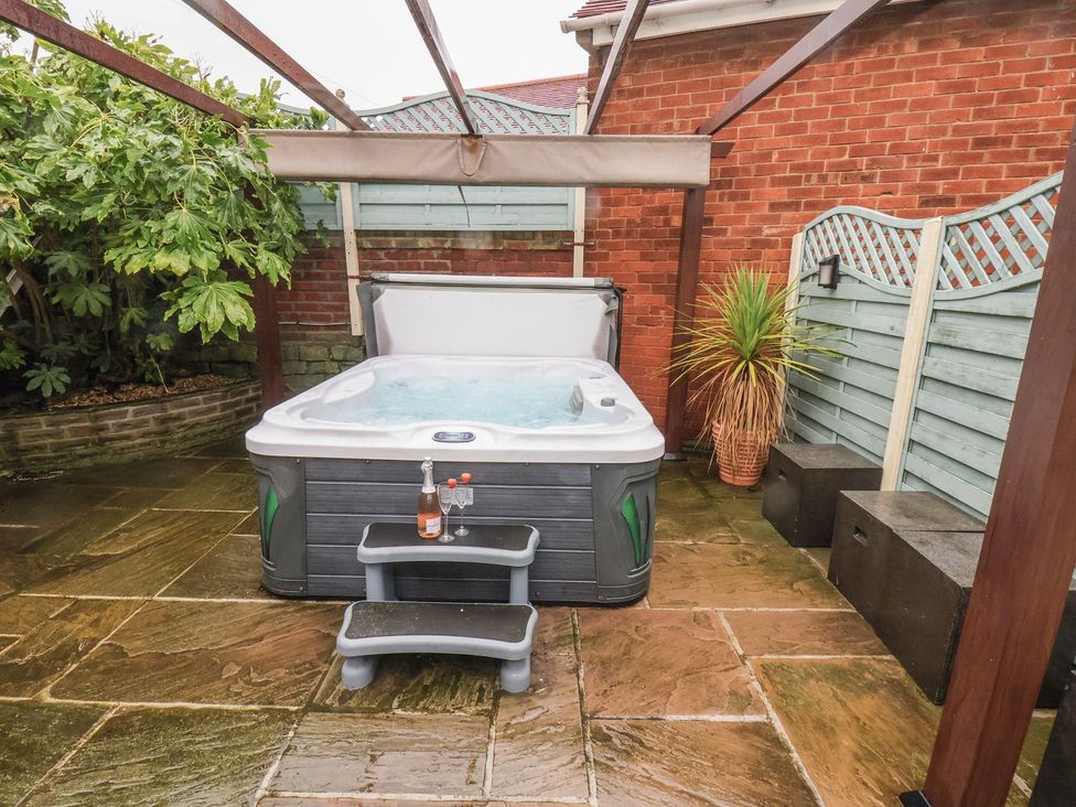 A garden with a hot tub and steps at Beachcrest in Whitby