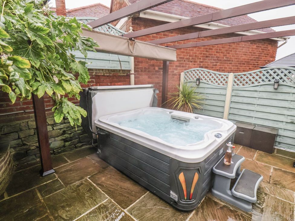 A hot tub with steps and plants in an outdoor area at Beachcrest in Whitby