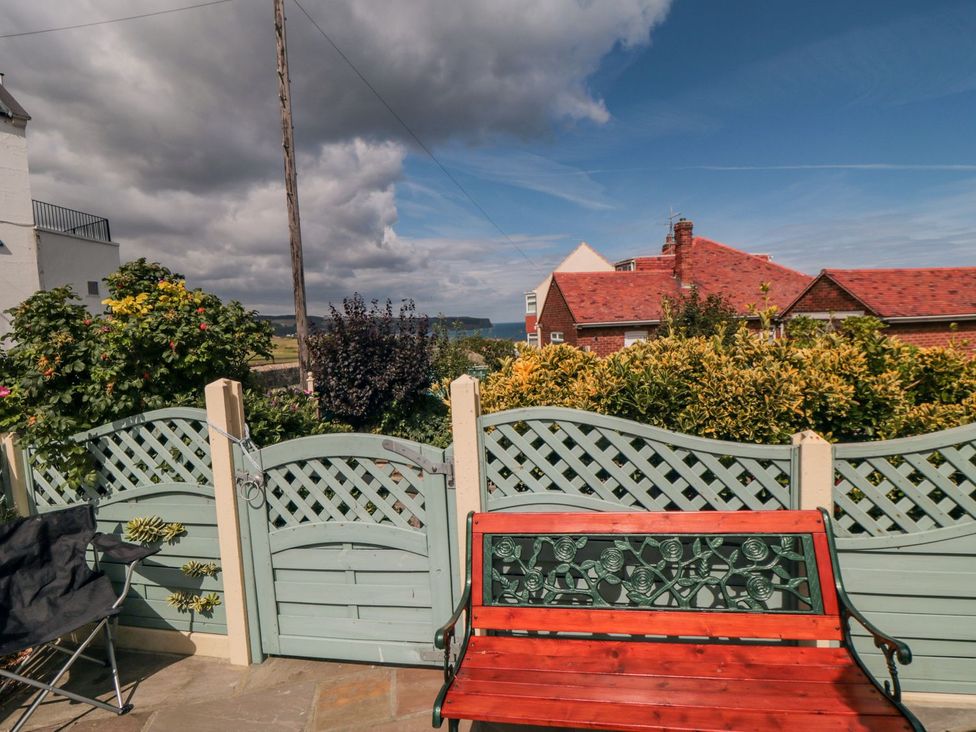 A garden with a bench and plants at Beachcrest in Whitby
