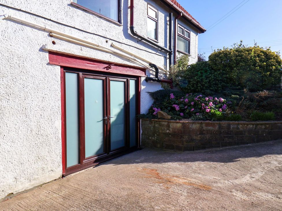 An outdoor space with a door and flowers at Beachcrest in Whitby